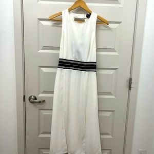 White tea length dress with dark navy band in back